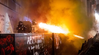 Federal officers use chemical irritants and crowd control munitions to disperse Black Lives Matter protesters in Portland. AP