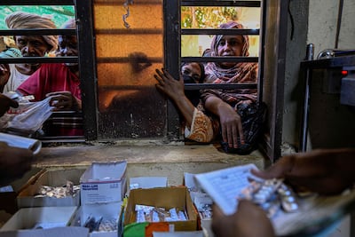 Sudanese people in Omdurman wait to receive medicine at Al Nao Hospital. AFP