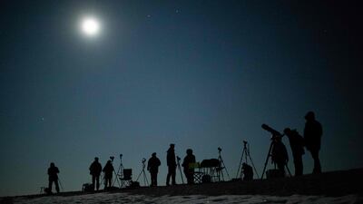 People gather to watch the 'blood moon' total lunar eclipse over Vienna, Austria. AFP