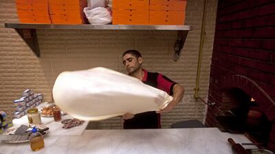 Ajman, August 8, 2011 - Hamdy Mohammad Zaki stretches the dough to make a Fatir, a flat bread pastry that is filled with meat or vegetables, at the Shabrawy Restaurant on the corniche in Ajman City. Zaki moved from Cairo at the suggestion of his cousin wh???