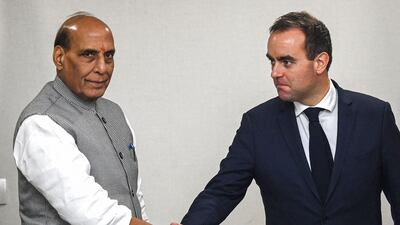 French Defence Minister Sebastien Lecornu, right, shakes hands with India's Defence Minister Rajnath Singh before a meeting in New Delhi on November 28, 2022. AFP