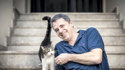 Animal rescue volunteer and former UAE resident Andreas Rosener with a rehomed cat. Courtesy Andreas Rosener