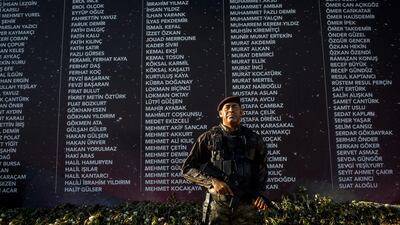 A statue of a soldier is seen in front of a wall showing the names of people killed during the events of the July 15, 2016 coup attempt at an anniversary site setup to mark the first anniversary of the failed coup attempt in Taksim square on July 12, 2017 in Istanbul, Turkey. Chris McGrath/Getty Images