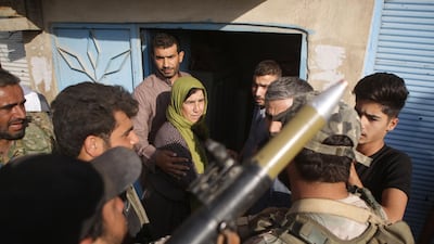 Turkish-backed Syrian fighters speak with locals, who didn't flee their homes, in the border Syrian town of Tal Abyad, on the fifth day of a Turkish offensive in Syria. AFP