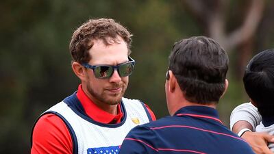 Caddie Kessler Karain (L) shakes hands with his player Patrick Reed. AFP