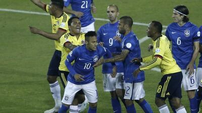 Carlos Bacca, left, shoves Neymar after the end of Colombia's victory over Brazil. Both players received red cards. Silvia Izquierdo / AP Photo