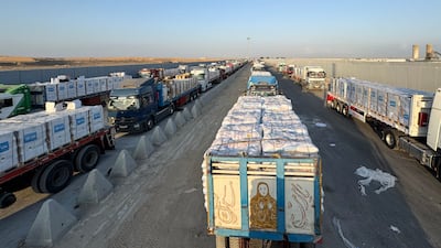Trucks loaded with humanitarian aid await permission on the Egyptian side of the Rafah crossing with the Gaza Strip on Sunday. AFP