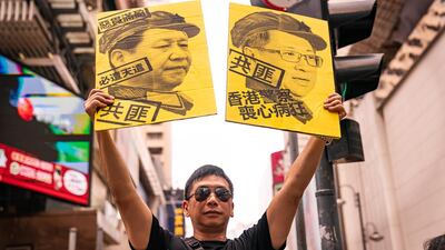 Protesters hold banners and shout slogans as they march on a streetin Hong Kong China. Getty Images