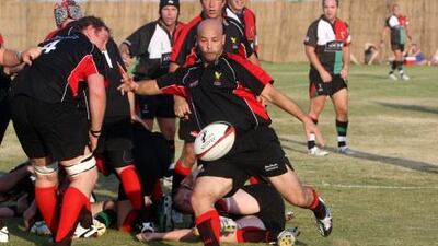 An Abu Dhabi Saracens player executes a box kick.