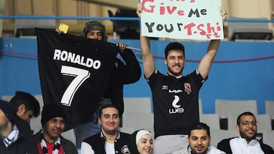A Juventus fan holds up a sign for Cristiano Ronaldo before the match. Reuters