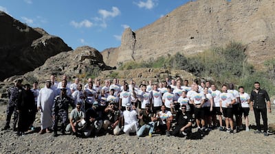 Volunteers, officials and staff members of Wadi Al Wurayah with the Special Olympics torch “Flame of Hope” in Wadi Al Wurayah Waterfalls in Fujairah. Pawan Singh/The National
