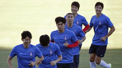 South Korea's Son Heung-min, left, leads a warm-up in training with his teammates in Brisbane, Australia, on January 15, 2015. Edgar Su / Reuters