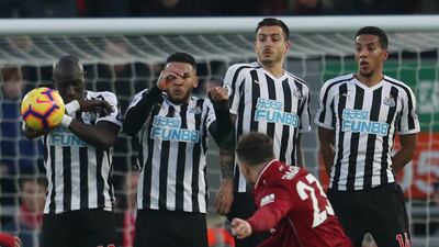 Shaqiri shoots at goal from a free kick as Newcastle United's Mohamed Diame, Jamaal Lascelles and teammates attempt to block. Action Images via Reuters