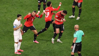 Egypt players react as referee Szymon Marciniak calls an off-side to overturn the goal by Shoja Khalilzadeh of Iran. AFP