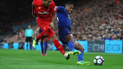 Antonio Valencia of Manchester United, right, is tackled by Roberto Firmino of Liverpool during the Premier League match at Anfield on October 17, 2016 in Liverpool, England. Clive Brunskill / Getty Images