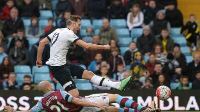 Tottenham Hotspur’s English striker Harry Kane shoots past Aston Villa’s Scottish defender Alan Hutton to score his team’s first goal during the Premier League match between Aston Villa and Tottenham Hotspur at Villa Park in Birmingham, central England on March 13, 2016. AFP / OLI SCARFF
