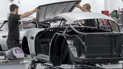 Employees fit the bonnet to one of the DB4 GT Zagato Continuations. Courtesy Aston Martin.