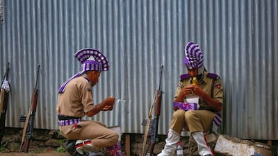 Police officers in ceremonial dress relax after taking part in a parade to celebrate the 75th anniversary of Indian independence, in Srinagar. EPA