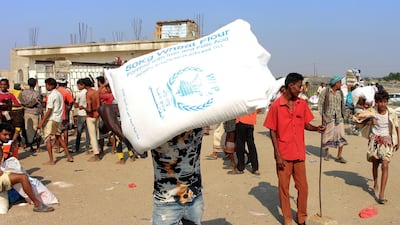 Displaced Yemenis receive humanitarian aid, donated by the World Food Programme (WFP) in cooperation with the Danish Refugee Council ( DRC), in the northern province of Hajjah on December 30, 2019. AFP