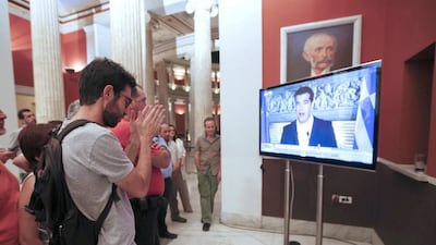 No supporters watch Greek prime minister Alexis Tsipras speaking on TV=. Jean-Paul Pelissier / Reuters