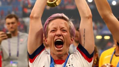 Rapinoe celebrates with the trophy. Reuters