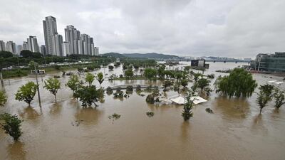 A park beside the Han river is flooded following heavy rainfall in Seoul. AFP