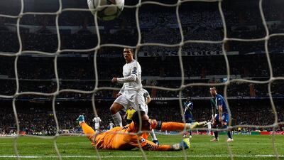 Cristiano Ronaldo of Real Madrid beats goalkeeper Diego Benaglio of VfL Wolfsburg to score their first goal during the Uefa Champions League quarter final second leg match between Real Madrid CF and VfL Wolfsburg at Estadio Santiago Bernabeu on April 12, 2016 in Madrid, Spain. (Photo by Mike Hewitt/Getty Images)