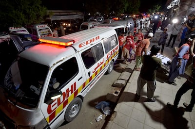 Medical workers arrive at a hospital in Karachi with the bodies of the victims of a bus accident in Balochistan province. EPA