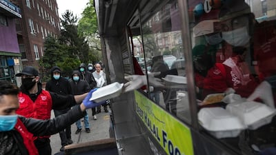 People queue up for free food in the Bay Ridge neighborhood of Brooklyn New York. AP Photo