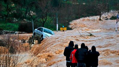 Flash floods caused by torrential rain go down a street on the outskirts of Jerusalem. AFP