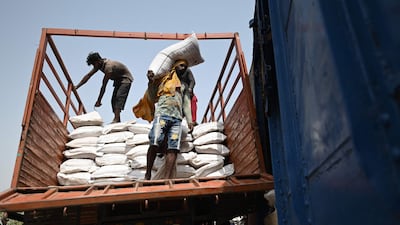 Workers load sacks of wheat on a freight train in Khanna, Punjab state. India, the world's second-largest producer of wheat, has banned exports without special authorisation from the government. AFP