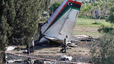 An investigator walks near the wreckage of a Libyan military plane near Grombalia town, south of Tunis. The Libyan military plane carrying medical patients crashed killing all 11 crew and passengers on board after an engine failure. Anis Mili / Reuters