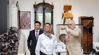 Sulaiman Hamid Almazroui and Noura Al Kaabi listen to Mr Stanley as they tour the Furniture Galleries. Eleanor Bentall for The National