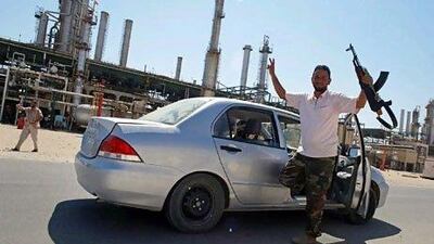 Rebel fighters celebrate after taking full control of the Zawiyah oil refinery. Reuters