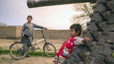 In Kandahar, where playgrounds are largely unavailable, children play on an old Soviet tank. Conflict is all-present in the southern province and eighteen years of American invasion haven't defeated the Taliban. Photo by Stefanie Glinski