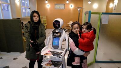 Afghan girls pose for a photo with Timea at the Times Fast Food restaurant. Reuters