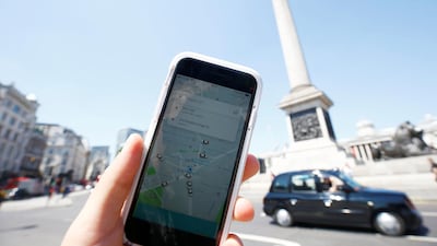 A photo illustration shows the Uber app and a black cab in London. Henry Nicholls/ Reuters
