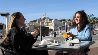 Customers have breakfast as they sit on a terrace at the Vieux-Port in Marseille, southern France. AFP