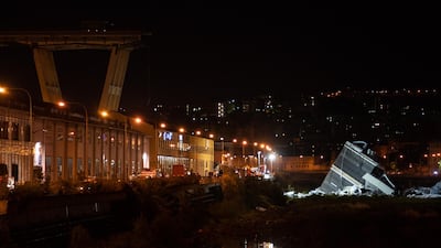 A section of the Morandi motorway bridge lays on the ground at night after it partially collapsed in Genoa, Italy, on Tuesday, Aug. 14, 2018. The bridge on the main highway running down the Italian Mediterranean coast in the port city collapsed, and reports said at least 20 people died with others trapped in the rubble. Photographer: Federico Bernini/Bloomberg