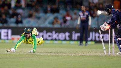 Australia's Alex Carey, left, is runout for 38 runs by India's KL Rahul in Canberra on Wednesday. AP