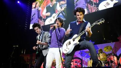 The Jonas Brothers from left, Nick, Kevin and Joe perform in New Jersey. The pop group is currently on a world tour that will take them from points ranging from San Antonio to Abu Dhabi.
