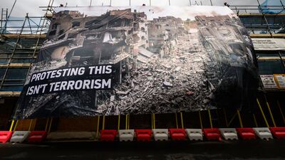 A large protest banner, attached to scaffolding opposite the central London headquarters of the Labour Party. Getty Images