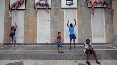 Children play basketball with an installation by Spanish artists Martin and Sicilia. REUTERS