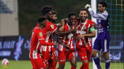 Al Jazira forward Ali Mabkhout, right, celebrates with teammates after scoring a penalty against Al Dhafra to break the UAE league goals record. Photo: PLC