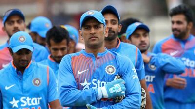 MS Dhoni, centre, has stepped down as India's limited overs captain after 10 years in the role. Jekesai Njikizana / AFP