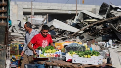 Palestinian sellers display their goods near the rubble after the Israeli army demolished 16 shops at the produce market in Beita village south of Nablus in the occupied West Bank. AFP