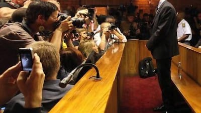 Oscar Pistorius stands in the dock during his bail hearing at the magistrate court in Pretoria. Themba Hadebe / AP Photo