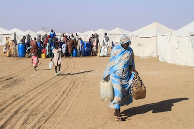 Displaced Sudanese who fled El Fasher collect water at Al Afad camp in Al Dabba, northern Sudan. AFP