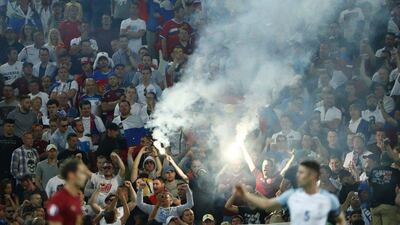 England’s Gary Cahill looks on as a flare is let off in the crowd during his team’s match against Russia at Euro 2016 in France. Eddie Keogh / Reuters
