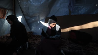 Displaced Palestinians shelter in a tent after an Israeli strike on Nuseirat, in central Gaza. AFP